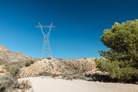 Picturesque landscape scene, Power line pylon in mountainous area. High quality photo