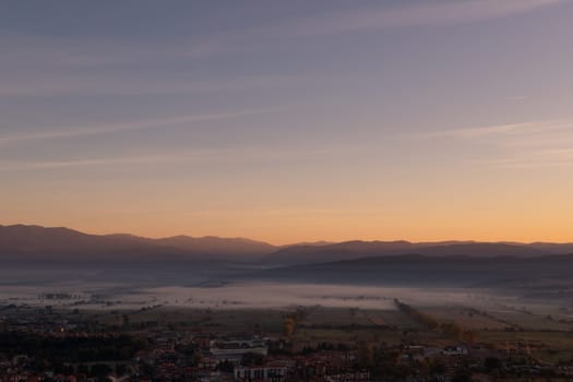 aerial view of foggy morning autumn mountains with clouds bansko bulgaria.