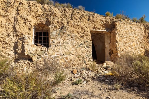 abandoned house against a backdrop of green grass and mountains. High quality photo