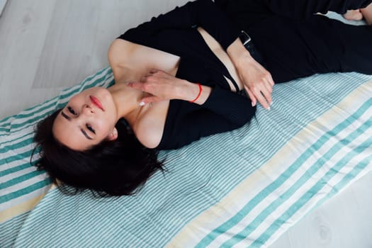 woman lying on sleeping mattress on the floor