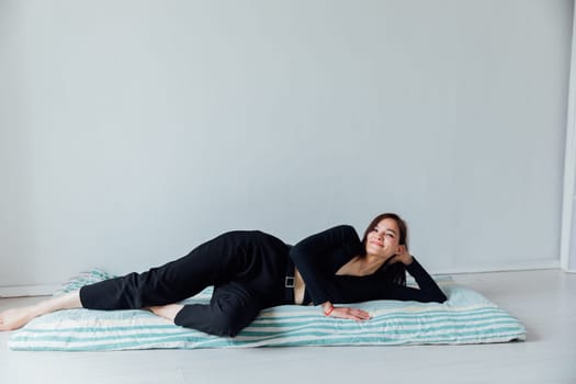 woman lying on sleeping mattress on the floor