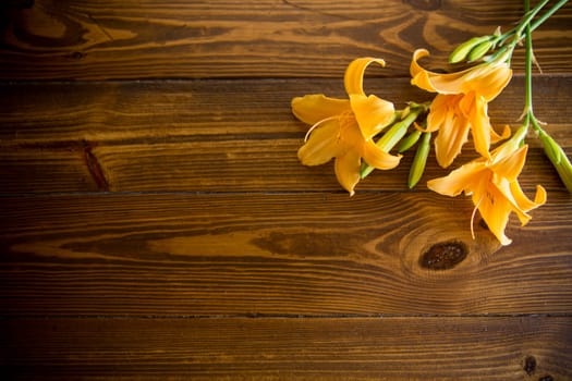 bouquet of beautiful yellow lilies on a dark wooden table