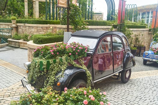 Vintage car decorated with flowers in the photo zone in a romantic style. High quality photo