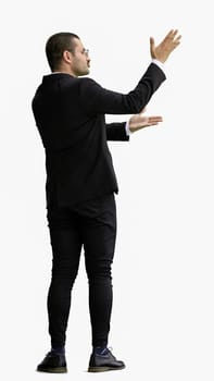 young man in full growth. isolated on a white background shows hands to the side.