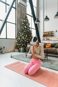 The yoga teacher utilizes virtual reality technology to conduct online sessions during the holiday season. High quality photo