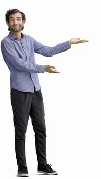 young man in full growth. isolated on white background demonstrates with hands.