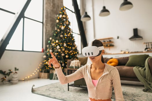 Amidst the Christmas holidays, a fashionable young woman uses a virtual reality headset. High quality photo