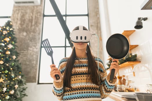 The kitchen sees a young, beautiful woman cooking while wearing a virtual reality headset. High quality photo