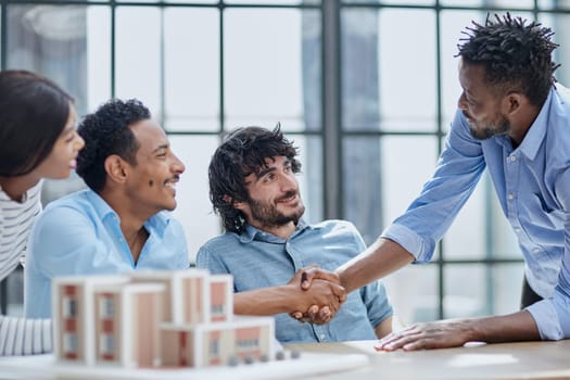 Agreement, business meeting, professional team in corporate office. Handshakes and smiles represent success.