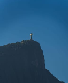 Stunning view of Rio's iconic Christ the Redeemer statue against a clear blue sky, providing ample text space and offering a striking silhouette.