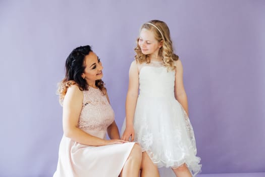 Family mom with daughter in light dresses