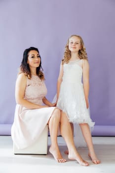 Family mom with daughter in light dresses