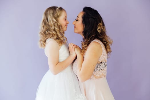 Family mom with daughter in light dresses