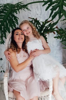 Family mom with daughter in light dresses