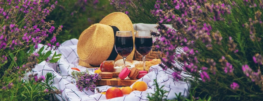 A woman drinks wine in a lavender field. Selective focus. Nature.