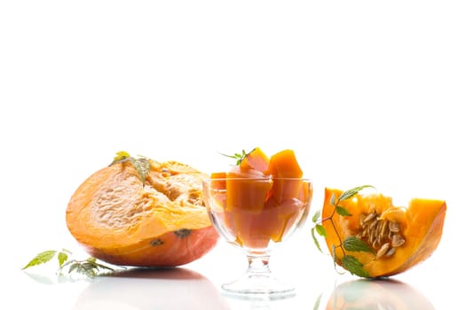Prepared sweet pumpkin marmalade in a glass bowl isolated on a white background. Autumn recipes.