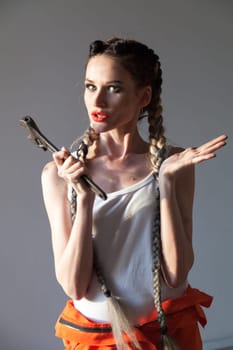 Portrait of a beautiful fashionable woman mechanic with two braids