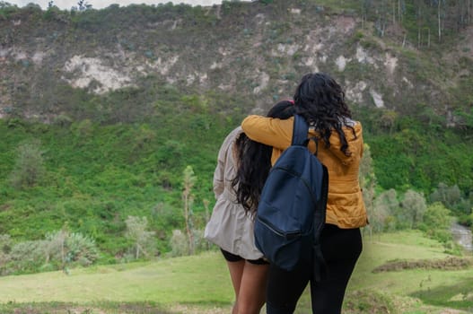 two girls hugging each other, demonstrating the love they feel for each other while breathing the pure mountain air. High quality photo