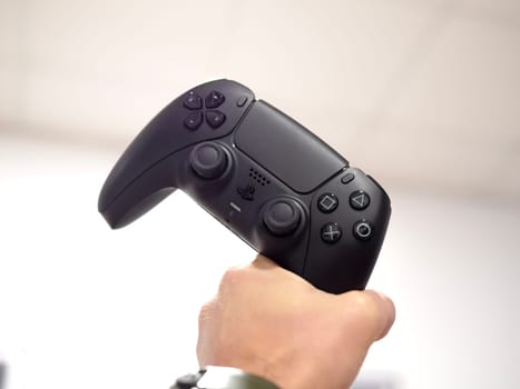 Tbilisi, Georgia, November 30, black PlayStation 5 joystick in hand. holding ps5 joystick