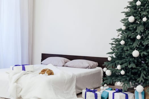 New year bedroom decor with Christmas tree bed with gifts and garlands