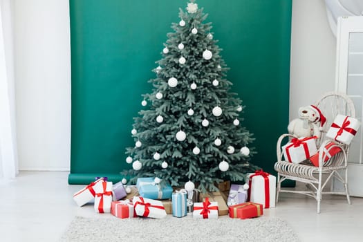 New Year's Christmas tree decor with gifts and interior garlands