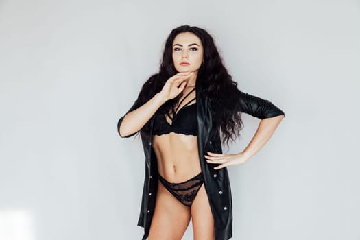 Portrait of a beautiful brunette woman in black lingerie