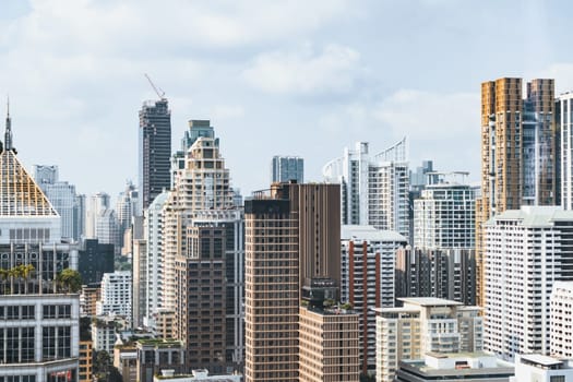 Closeup image of Bangkok cityscape. Modern cityscape surrounded with architectural building with day light and blue sky. Side view. Business background. Day light. Ornamented.