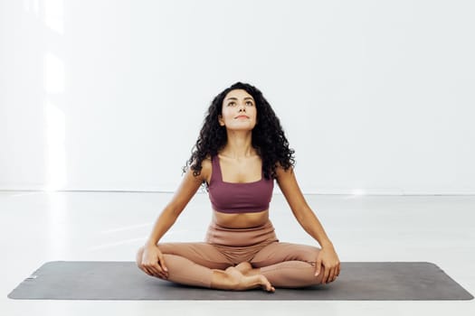 Beautiful brunette woman engaged in yoga asana flexibility body