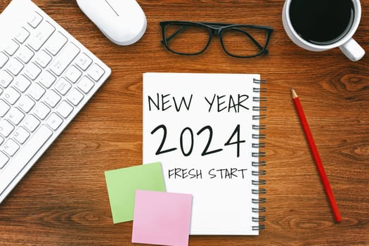 2024 Happy New Year Resolution Goal List and Plans Setting - Business office desk with notebook written about plan listing of new year goals and resolutions setting. Change and bliss concept.