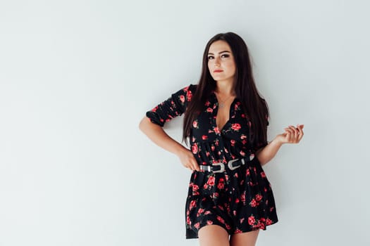 Portrait of a beautiful woman in a black dress with flowers