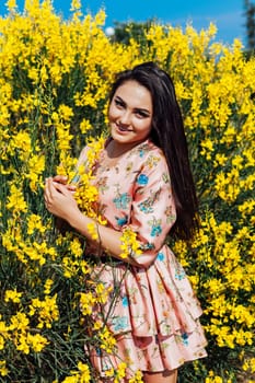 woman in a dress with flowers walks in the park alone