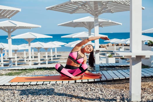 sports woman yoga gymnastics on the beach