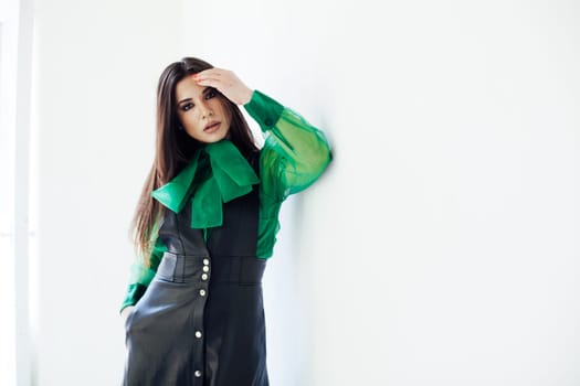 Portrait of a beautiful fashionable woman in black green leaf dress