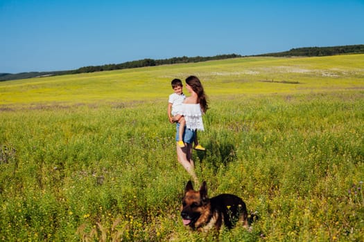 Mom with son on a walk in the field of summer family love