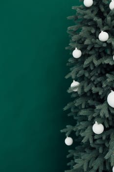 Christmas tree with presents underneath in living room. White room. Bright lights and bokeh.