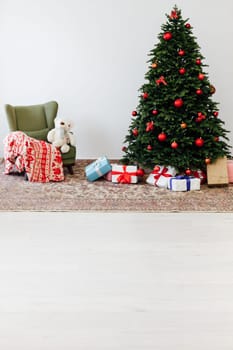 Beautiful holdiay decorated room with Christmas tree with presents under it.