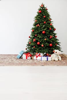 Beautiful holdiay decorated room with Christmas tree with presents under it.