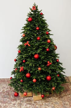 Beautiful holdiay decorated room with Christmas tree with presents under it.