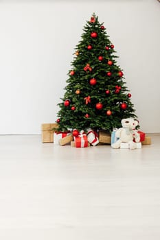 Beautiful holdiay decorated room with Christmas tree with presents under it.