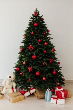 Beautiful holdiay decorated room with Christmas tree with presents under it.