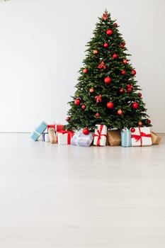 Beautiful holdiay decorated room with Christmas tree with presents under it.