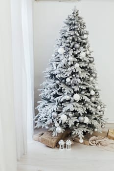 Home interior. A room with a beautiful snowy Christmas tree