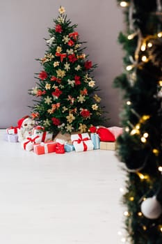 Beautiful holdiay decorated room with Christmas tree with presents under it