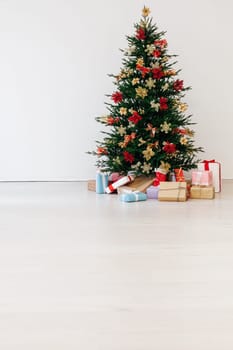 Beautiful holdiay decorated room with Christmas tree with presents under it