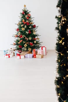 Beautiful holdiay decorated room with Christmas tree with presents under it