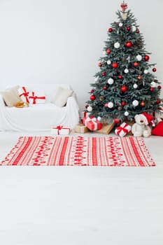 Beautiful holdiay decorated room with Christmas tree with presents under it