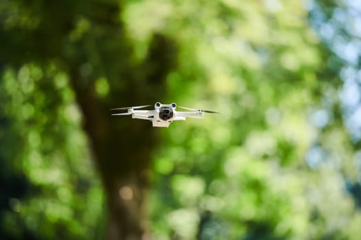 Professional drone filming the park on a sunny day.