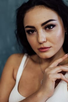 Portrait of a beautiful brunette woman in a white T-shirt