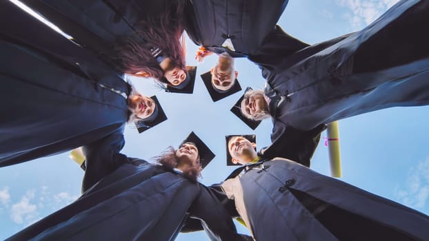 College students stand in a circle wearing black robes