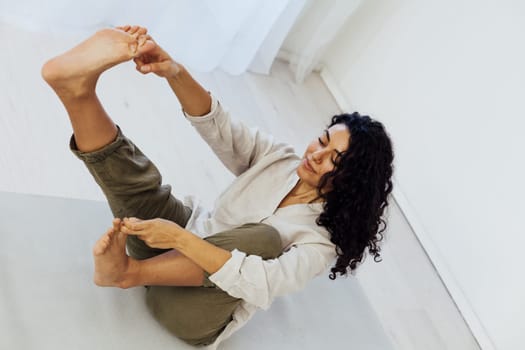 Brunette woman engaged in yoga asana flexibility body